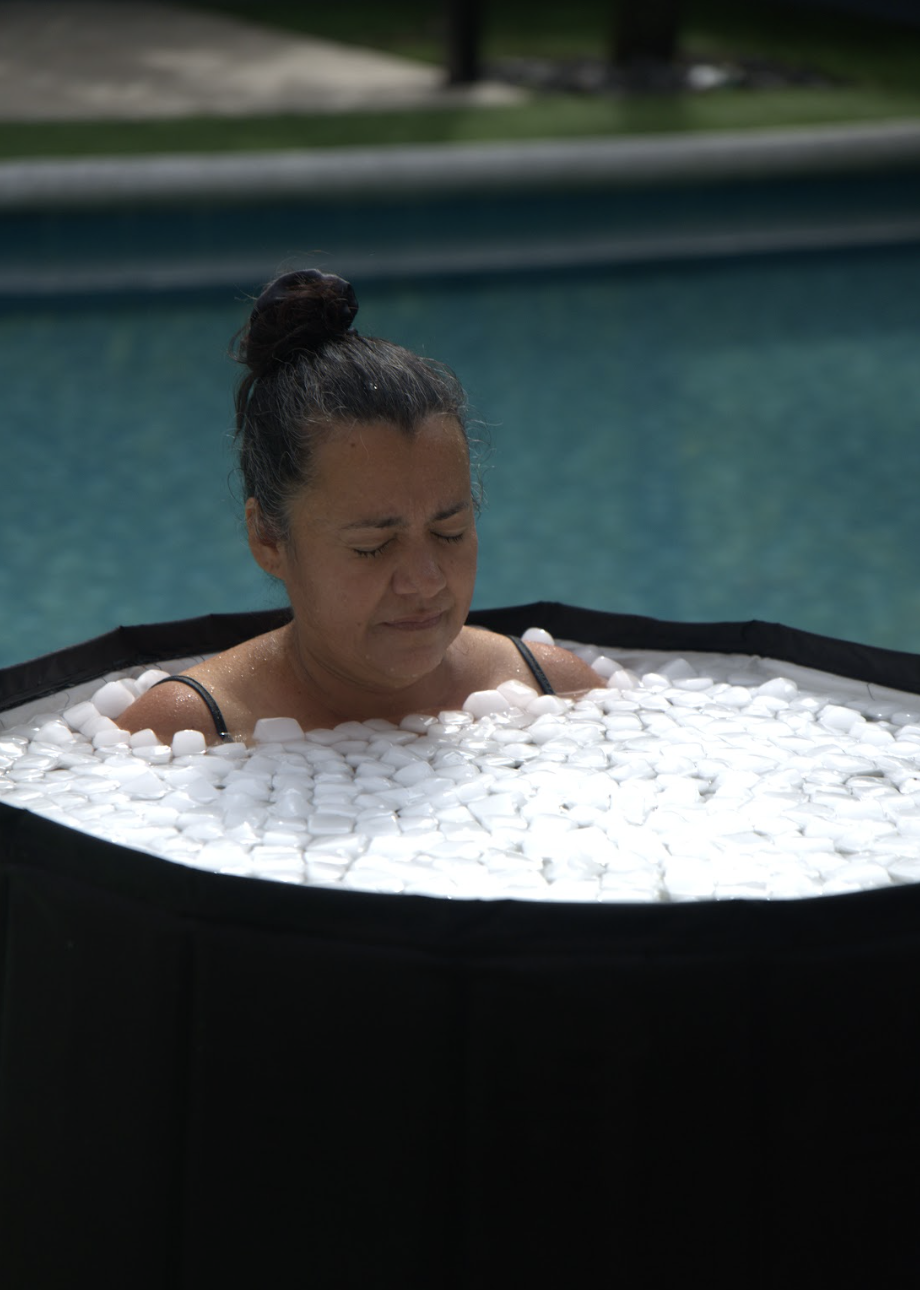Mujer con los ojos cerrados en calma dentro de la tina de hielo